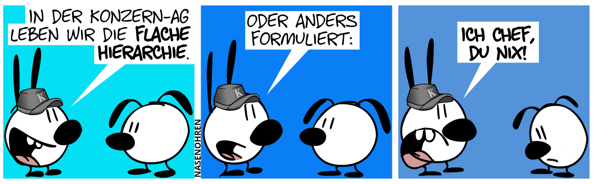 Mimi trägt eine graue Mütze mit dem Buchstaben ‚K‘. Mimi sagt zu Eumel: „In der Konzern-AG leben wir die flache Hierarchie.“ / Mimi: „Oder anders formuliert:“ / „Ich Chef, du nix!“. Eumel guckt bedrückt nach unten.